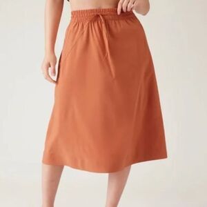Athleta ARRIVAL Jupe Orange Packable Travel  Athleisure Performance Wear Skirt